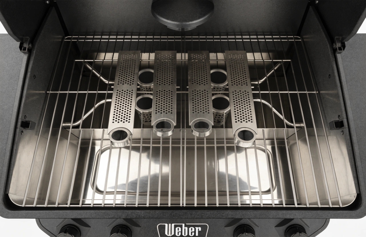 overhead-view-of-a-weber-bbq-interior-showing-clea Inside a professionally cleaned Weber BBQ showing clean burners and drip tray